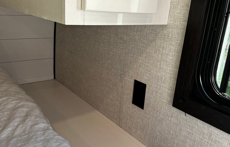 Nightstand with plug on each side of queen bed