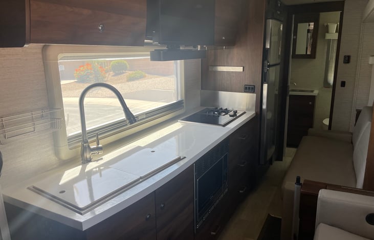 Double stainless sink with covers that are also cutting boards.  Plenty of cabinets and drawers.