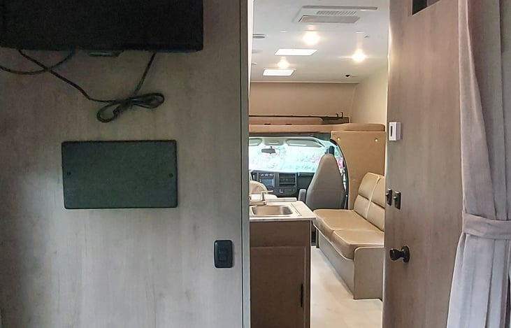 Entrance to main bedroom with TV on wall