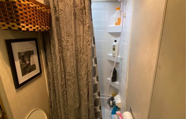 the bathroom has a shower with a small tub and upgraded porcelain toilet. please only use camper toilet paper.