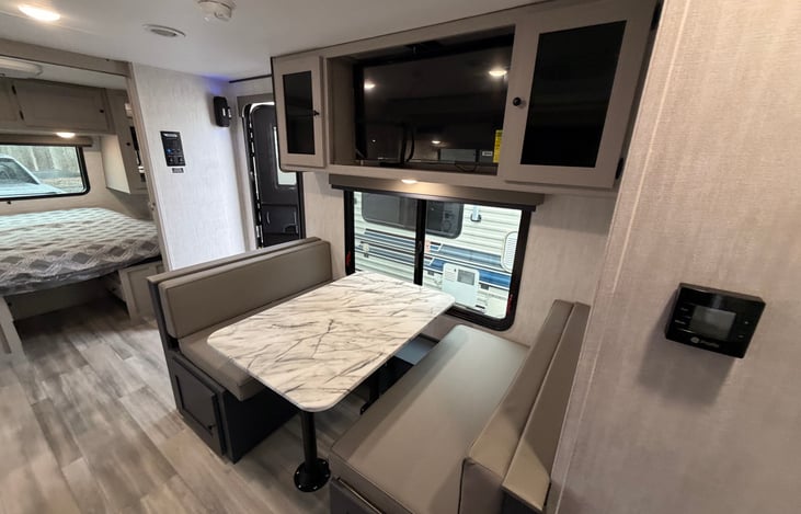 Booth dinnet, with window facing your campsite, this is unique as most campers do not have this payout and entertainment center above for all to see.