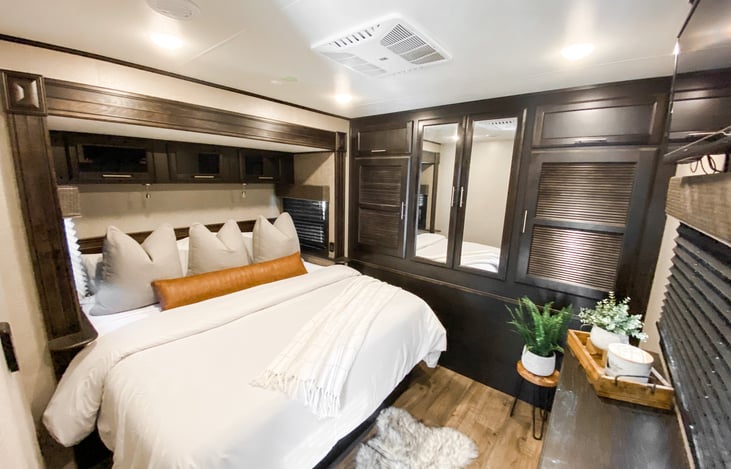 Upgraded residential king bed with foam mattress topper.  With its own AC, you'll sleep better than you did at home.