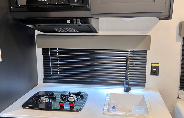 Small burner and sink.  You are camping most of cooking is outside normally anyways!