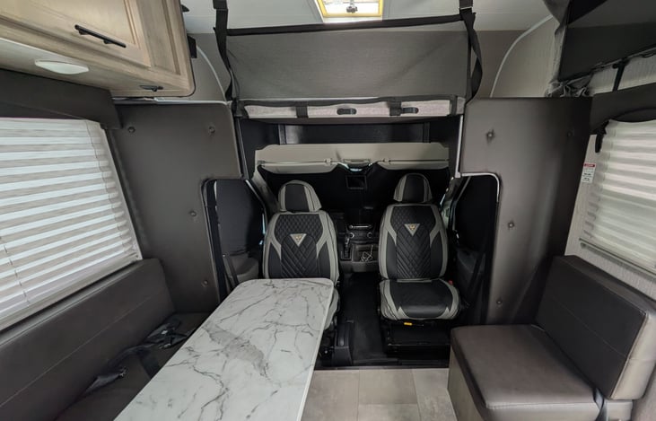 Driver seat and passenger seat swivels around to face the back.