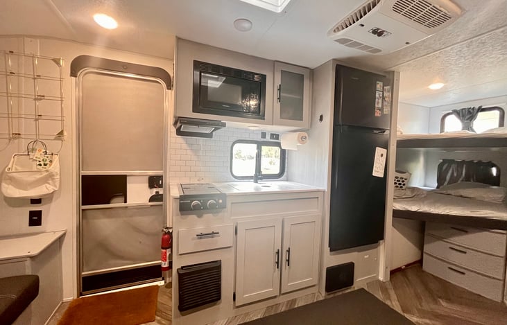 Sink, refrigerator, stove and microwave.