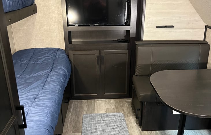 Dinette turns down into a bed, top bunk comes down. Bunk room sleeps 4