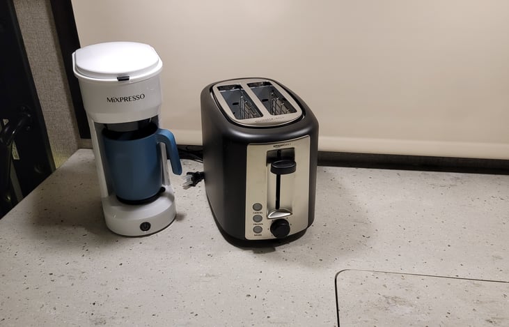 Coffee maker included, bring your single serving k-cups.  Toaster and Blender available for kitchen upgrade package (optional).