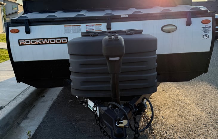 Exterior: Front Trailer Hitch, Gas Tanks, and Storage Compartment.