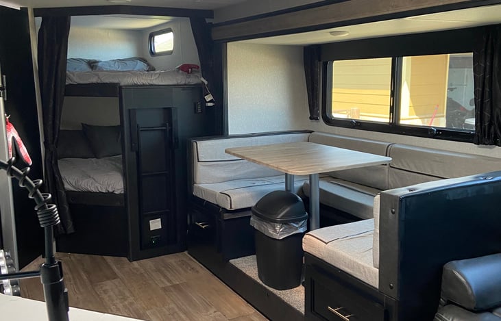 View of kitchen table that turns into Queen size bed also, a view of full size bunk beds