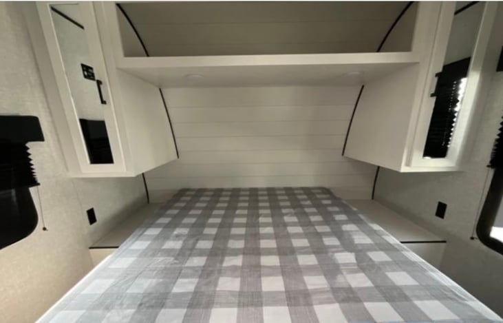 Small closets on each side of the bed and storage above