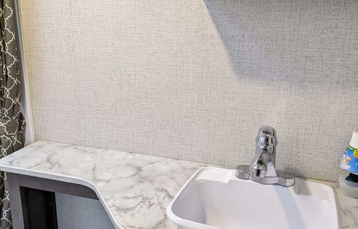 Spacious bathroom with shower, toilet, wash basin, medicine cabinet, etc.