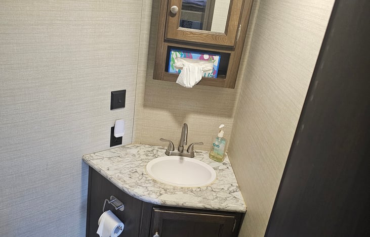Second bathroom located in the rear bunkhouse, with sink and toilet.