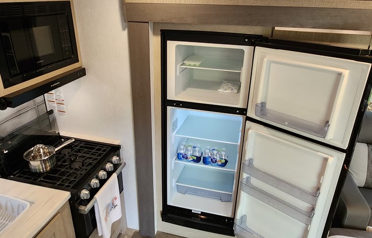 Large fridge & freezer.  Will continue working with solar power if camper loses electricity.  Bottled water will be included.