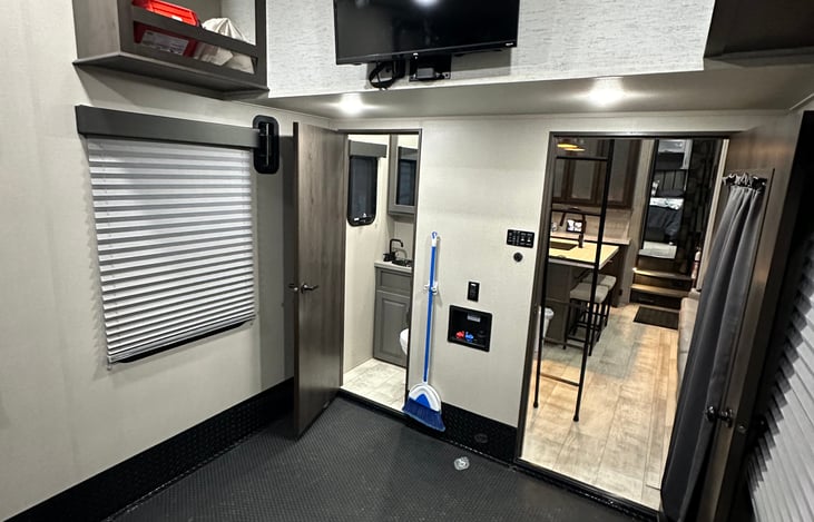 32" TV, 1/2 Bath, Upper Storage, Door to outside and main area