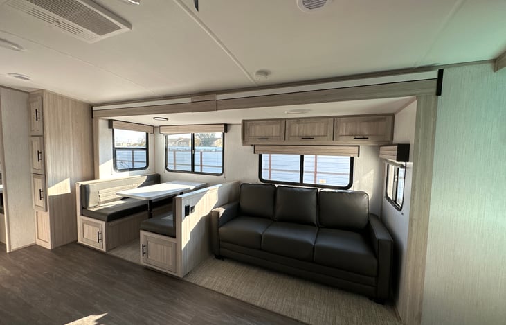 Right side of interior of trailer. 
Storage closet/ Dinette (converts into bed)/ Sofa sleeper
