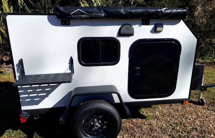 Fold out awning and side table. Flat fenders for more places to set things down.