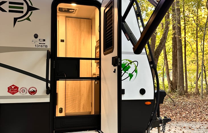 Screen door automatically latches to help keep bugs out! Sliding middle for a quick a pass though of food.