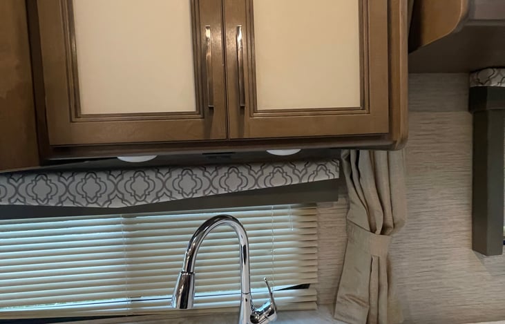 Cabinet space above the sink in the kitchen.