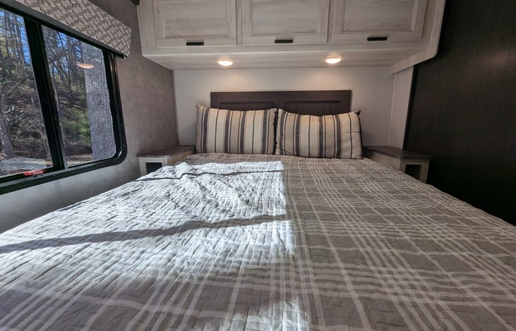 Cozy private bedroom with Queen bed and ample storage at the rear.