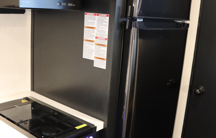 2 burning stove, and full RV style 12 Volt refrigerator. The trailer have duel batteries and 150 watts of solar on the roof to keep everything running.