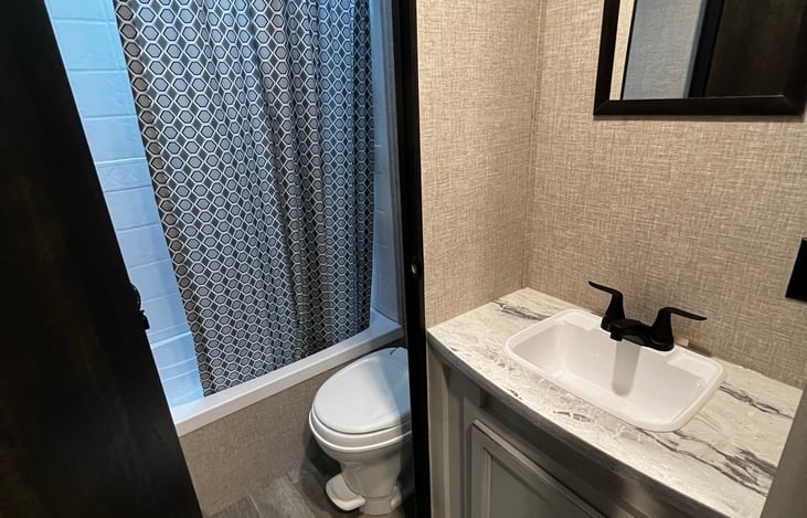 Bathroom sink, bathroom door open.