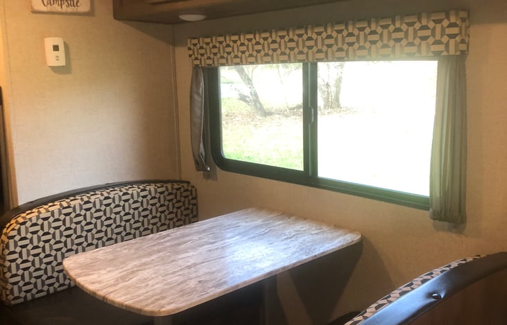 Dinette table that turns into twin bed with storage under seat