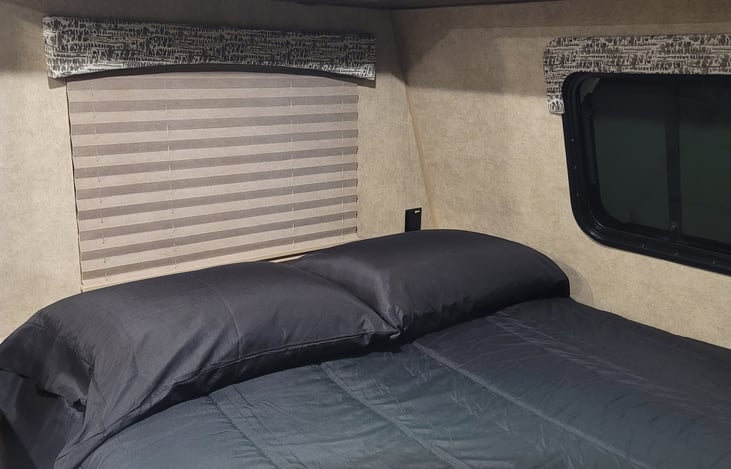 RV Queen bed, with upgraded mattress and always clean linens!