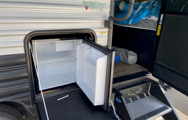 Outdoor fridge for drinks and grilling supplies.