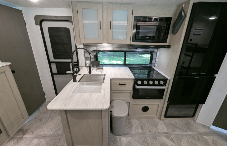 Bright and modern interior with spacious dinette with large windows. Large kitchen with plenty of counter space. Large bunks. TV with fireplace.