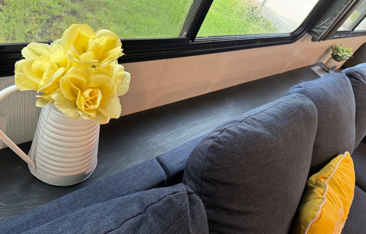 Custom built shelf behind the couch to hold drinks. It also has built in plugs to charge your phone.