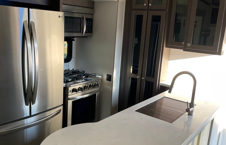 Full size oven, fridge, stove, microwave, and skink