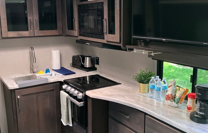 Kitchen with Mounted T.V and Coffee Station