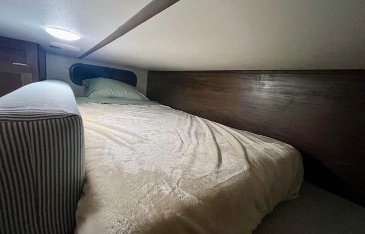Loft bed in main living area. It has a ladder to get up to it. I’d recommend it for a 10-20 year old. Must like small spaces.