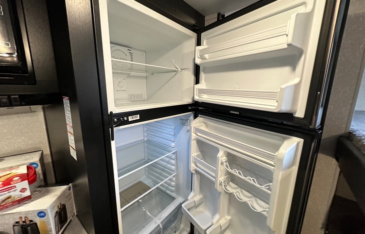 This is a crazy big fridge and freezer for an RV.  You are going to feel right at home.  Don't forget the ice cream!  The freezer stays running off solar and battery while you are on the road