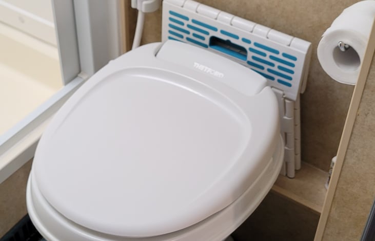 Toilet with spray. I'm short so the step stool is for me to turn the fantastic fan on🤣