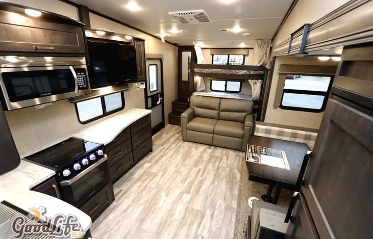 U shaped dinette allows plenty of room for eating or playing games.  Bunks open up to living area and television can swivel.