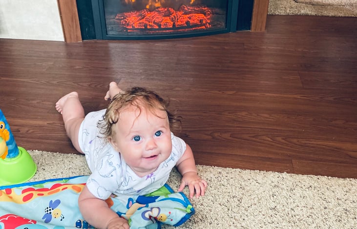 This is a picture of our 6 month old daughter, Blake. She is laying in front of the fireplace in the living space.