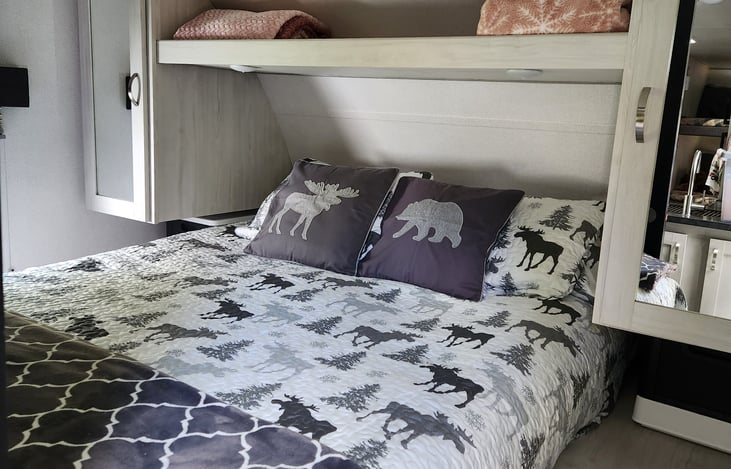 Queen size bed with closets on both sides, under and over bed storage. Sliding doors for privacy.