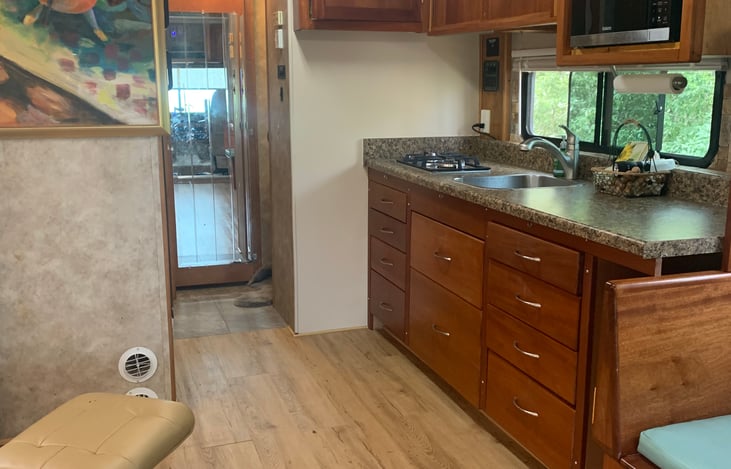 Plenty of counter space with gas burners and microwave. Pots and pans, dishes and utensils provided.