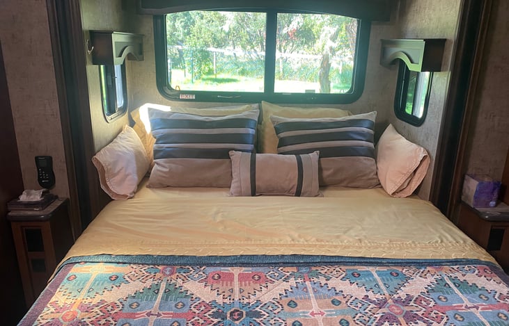 Queen sized bed with memory foam topper on an upgraded mattress