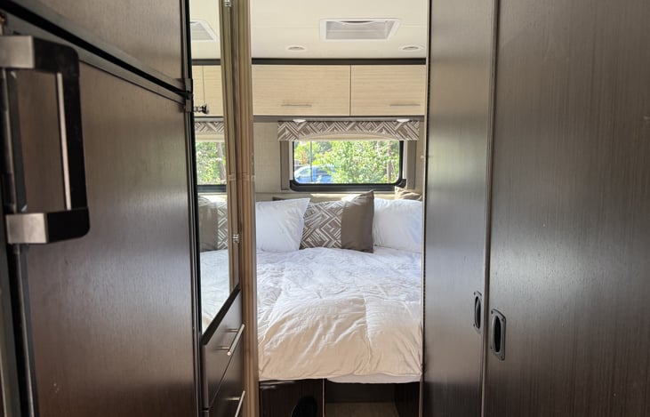view of the back sleeping area from the kitchen with bathroom doors to the right