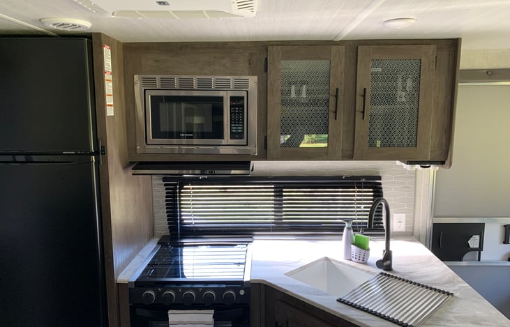 11 cubic foot refrigerator/freezer. 3 burner gas stove and oven. Microwave.