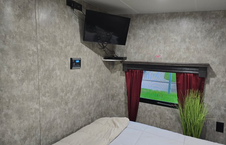 TV with DVD player connection mounted on wall.