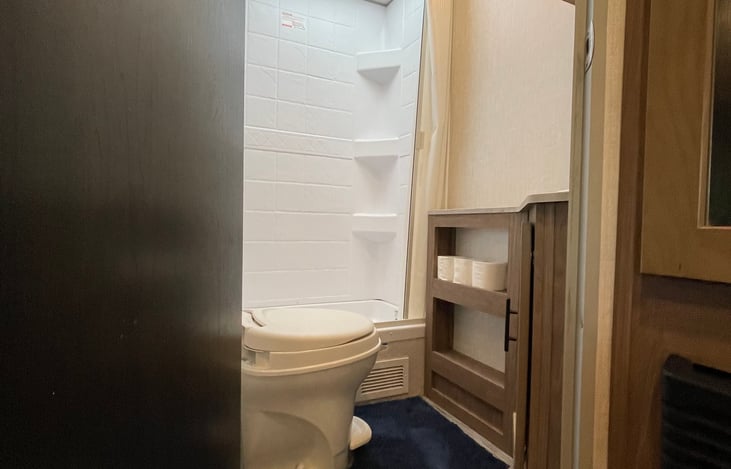 Full bathroom with vanity mirror and under sink storage.