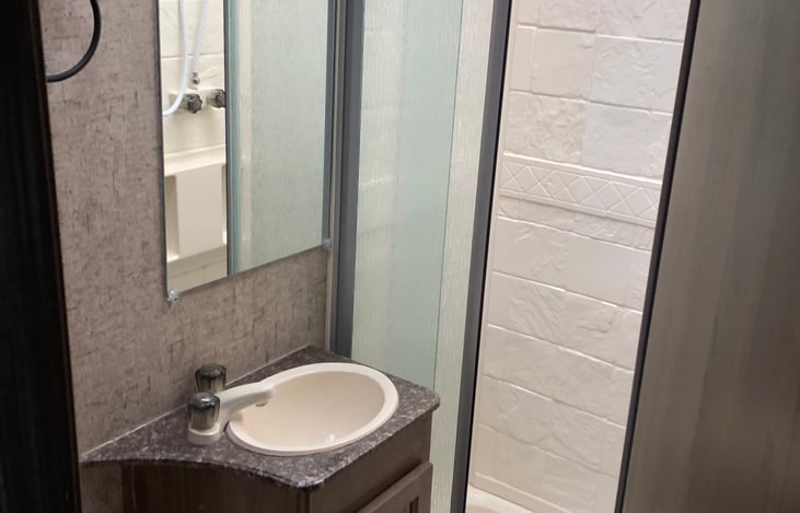 full size stand up shower and vanity with wash basin