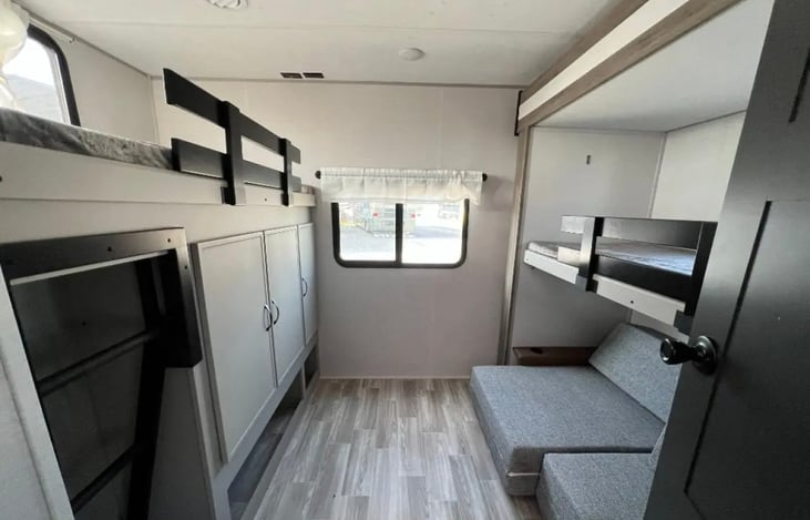 Bunkhouse room with 2 twin size top bunks and fold out sofa bed.