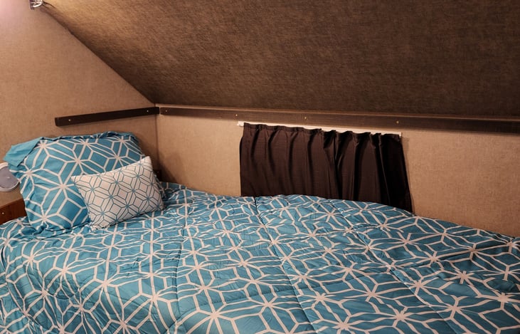 Twin bunk with fold down bunk above. 
Also, this bed can be removed and a table can be used instead of the bed.