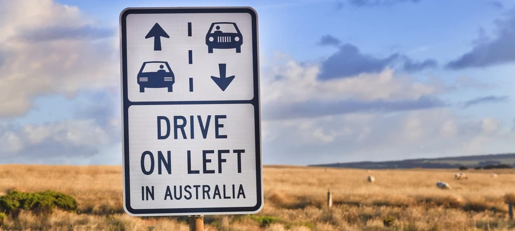Australian outback road sign "drive on left in australia" as a reminder for overseas tourists about road safety on Great Ocean Road