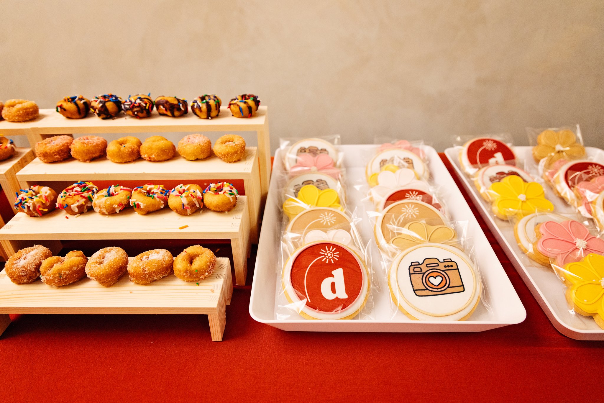 A table of donuts and decorated cookies