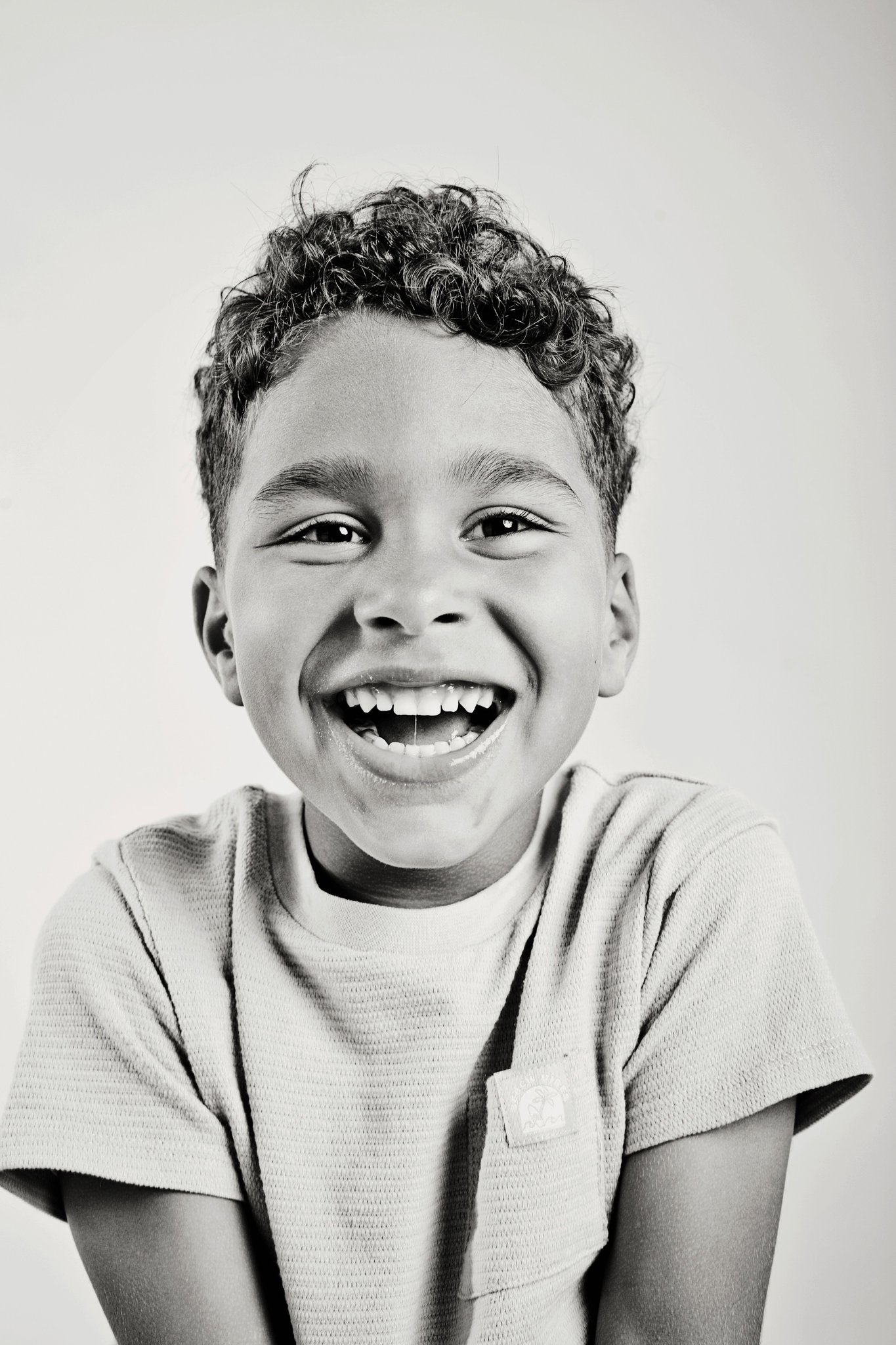 A boy laughing, black and white